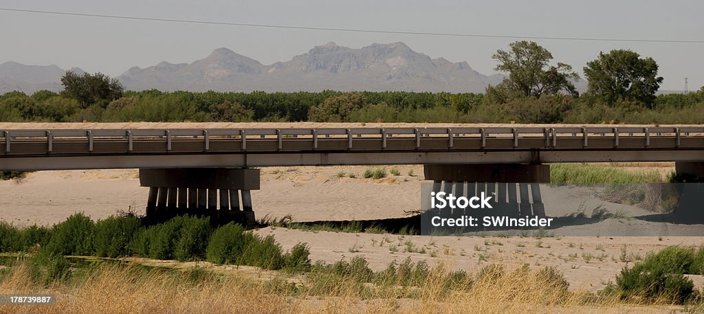 Bridge Over Dry Rio Grande "This bridge just south of Las Cruces, New Mexico spans the Rio Grande, which as of late May 2013 was dry due to a historic, severe drought. Only one water release  was scheduled from an upstream reservoir for a greatly shortened irrigation season during the summer.More desert irrigation, water, and drought photos:" Dry Stock Photo