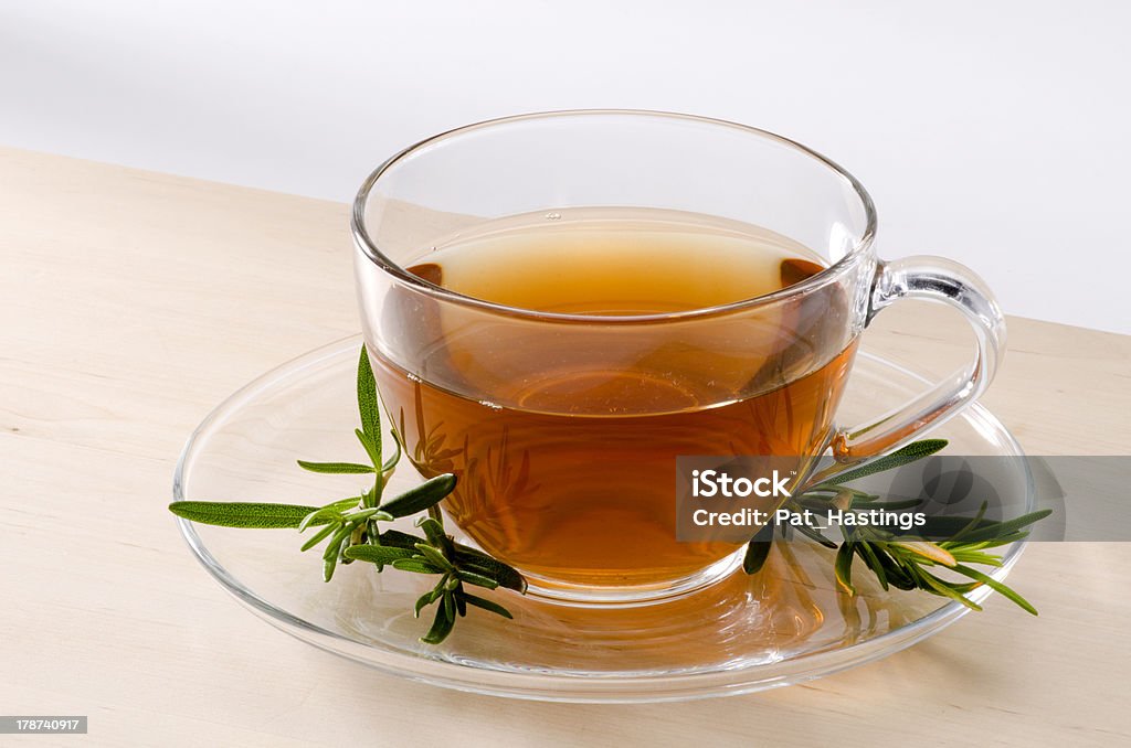 Rosemary Herbal Tea Rosemary Herbal Tea in a glass cup. Rosmarinus officinalis. Naturopathy. White Background. Alternative Medicine Stock Photo