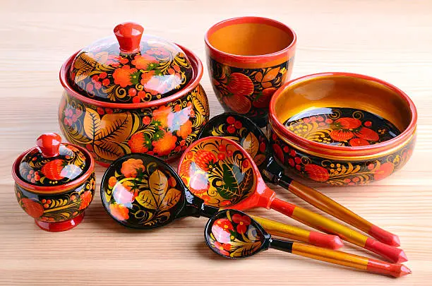 Kitchen utensils from Russian khokhloma. Traditional wood painting handicraft style and national ornament. First appeared in the second half of the 17th century in the Nizhny Novgorod.