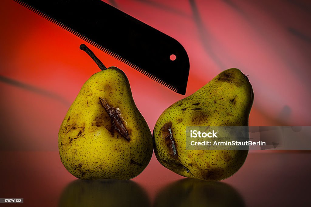 still life with two old pears and a saw still life with two old pears and a saw on a red vibrant background. Backgrounds Stock Photo