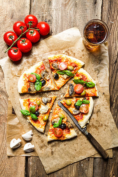 istock Freshly baked pizza served with a cold drink 178741553