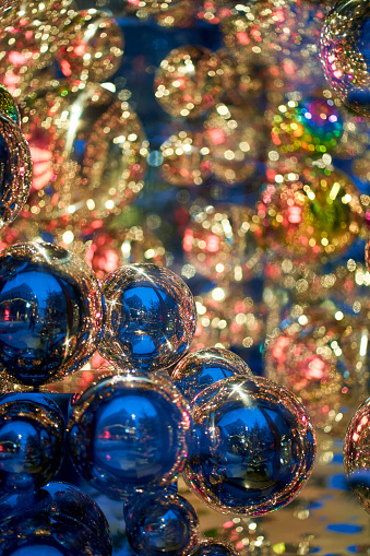 Christmas pattern. Blue and gold glass balls reflect. Deep bokeh, perfect for background.