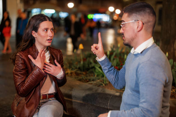 istock Couple Engages in Sign Language Dialogue on a Peaceful Street Bench 1787421491