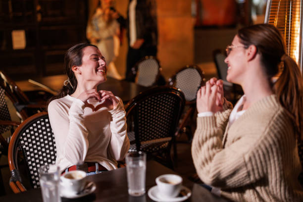 istock Two Female Friends Deep in Conversation in a Tranquil Cafe Garden 1787426255