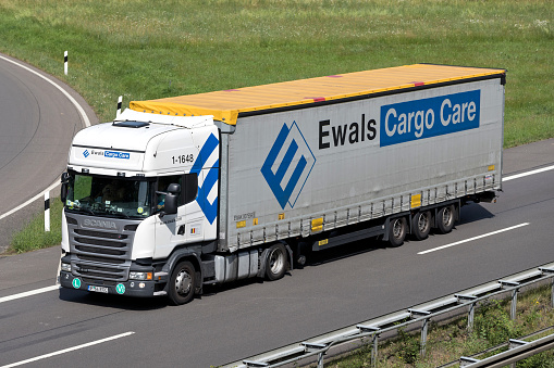 Wiehl, Germany - June 25, 2019: Ewals Scania truck with curtainside trailer on motorway