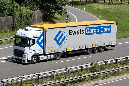 Wiehl, Germany - June 24, 2019: Ewals Mercedes-Benz Actros truck with curtainside trailer on motorway