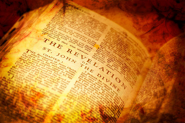 Open Bible showing The Revelation Bible showing The Revelation in distressed vintage style Bible stock pictures, royalty-free photos & images