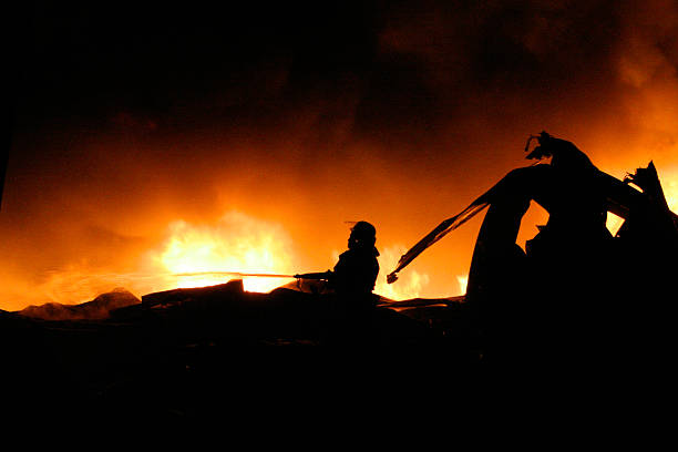 istock Silhouette of Firemen fighting a raging fire 178743208