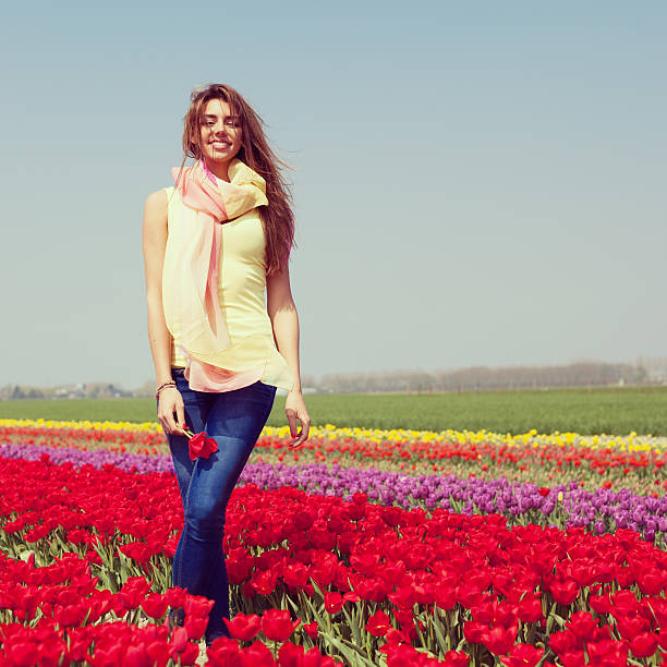 istock woman in red tulip field 178743457