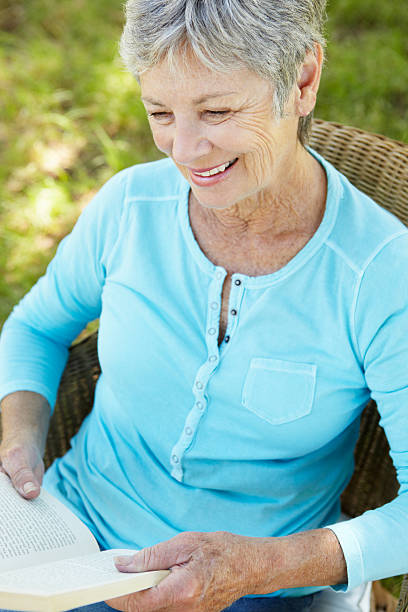 istock Senior woman reading a book 178743713