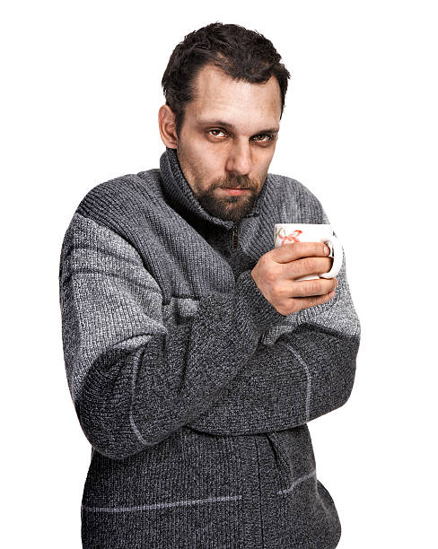 istock sick man holding a cup of tea in hands 178743968
