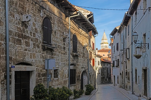 Picture of a typical street scene from the historic Croatian town of Voznjan with cobbled streets and old buildings in the morning light