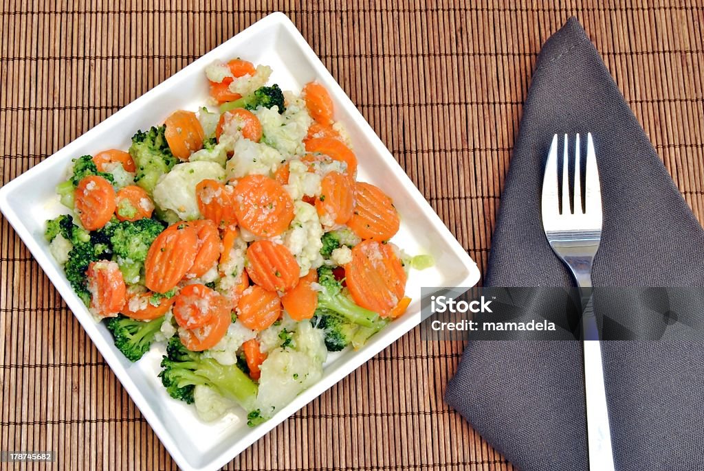 Cooked vegetables Cooked  vegetables in a plate  surrounded by bambu background Broccoli Stock Photo