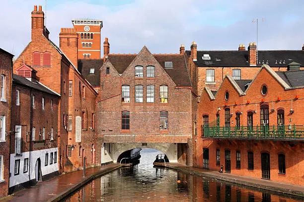 Photo of A river view of red brick buildings in Birmingham
