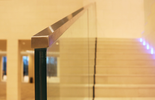 Laminated glass railing with stainless steel stair rail.