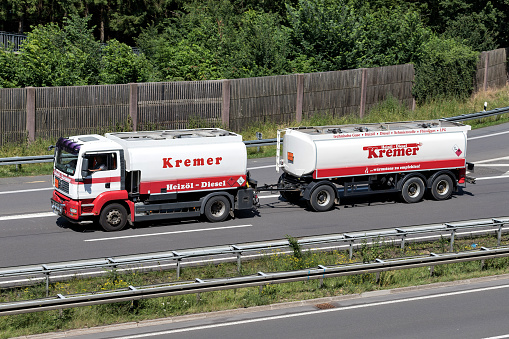 A truck with a bulk commodity trailer on a highway