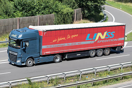 Wiehl, Germany - June 24, 2019: Linss DAF XF truck with curtainside trailer on motorway