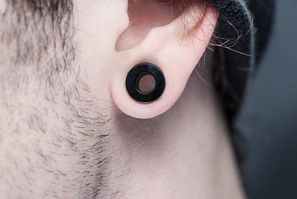 Flesh Tunnel Flesh-ear tunnel is one of body-modification style. Earlobe stock pictures, royalty-free photos & images