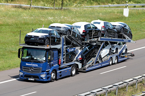 Wiehl, Germany - June 25, 2019: Manvesta Mercedes-Benz Actros car-carrying truck loaded with new Volkswagen Golf on motorway