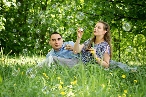 istock Couple in the woods blow bubbles 178746429