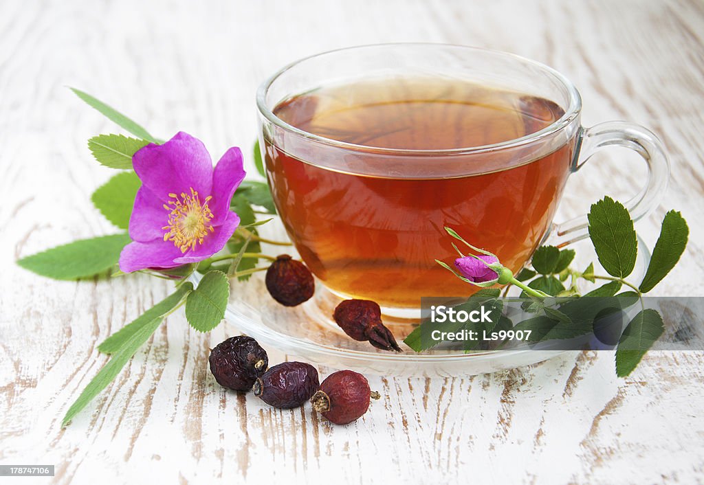 Rose hip tea Cup of rose hip tea on a wooden background Antioxidant Stock Photo