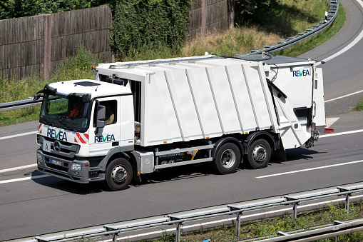 Wiehl, Germany - June 24, 2019: REVEA Mercedes-Benz Actros dustcart on motorway
