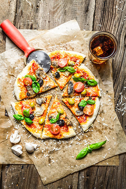 istock Cutting homemade pizza with basil 178747409