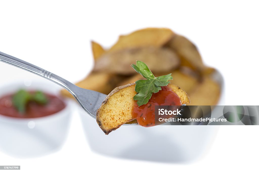 Potato Wedges on a fork (white) Potato Wedges on a fork isolated on white background Appetizer Stock Photo