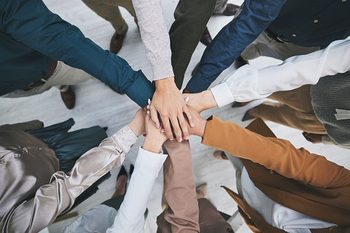 Hands together, team and support, solidarity and business people with top view, stack and community. Synergy, cooperation and huddle, collaboration and corporate group with trust, meeting and mission