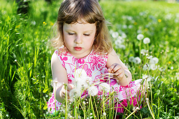 istock baby girl at dandelion meadow 178748210