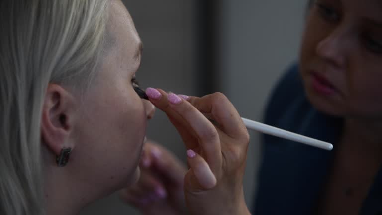 Make-up artist applying make-up foundation