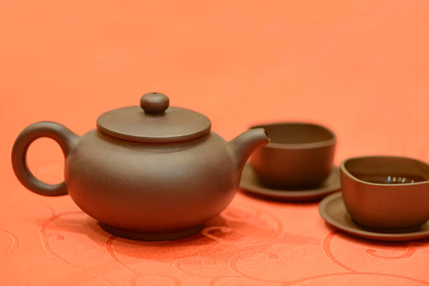 The dark-red enameled pottery，with two cups ,means communication