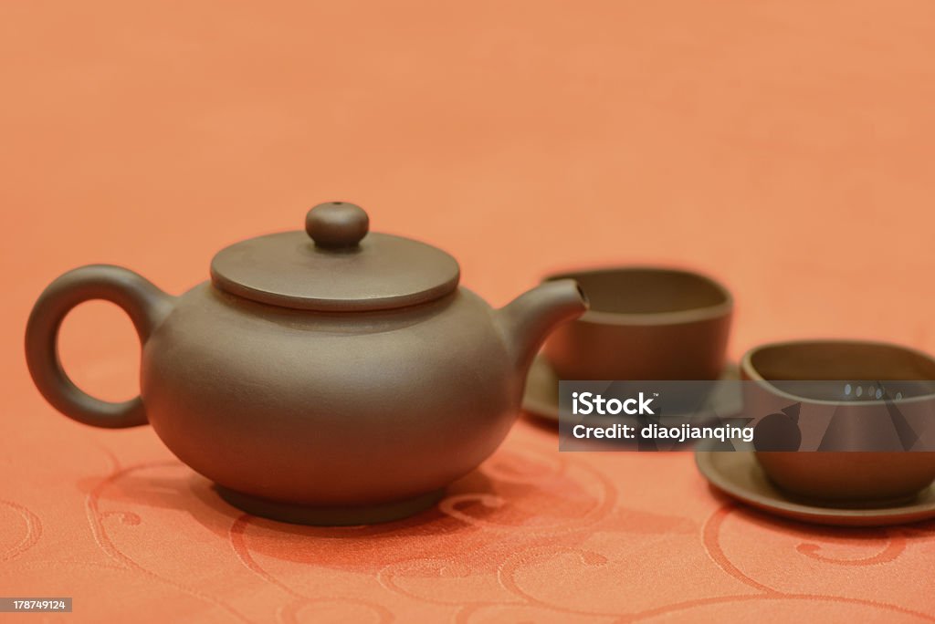 The dark-red enameled pottery，with two cups The dark-red enameled pottery，with two cups ,means communication Art Stock Photo