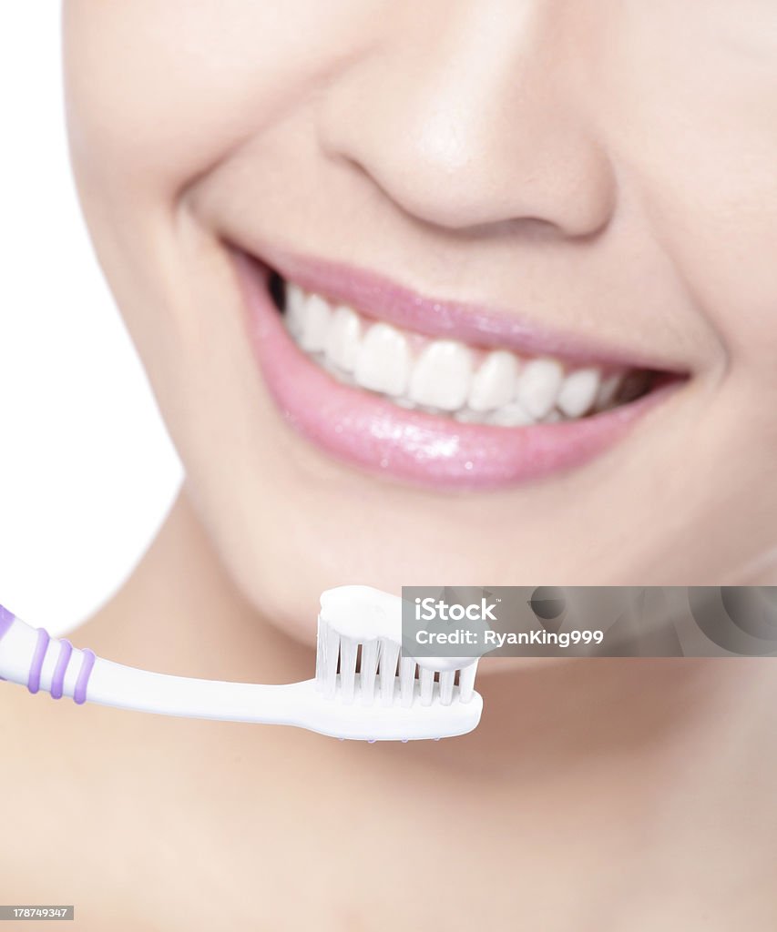 smiling woman cleaning teeth with toothbrush close up of Young smiling woman cleaning teeth with toothbrush, asian beauty model Adult Stock Photo