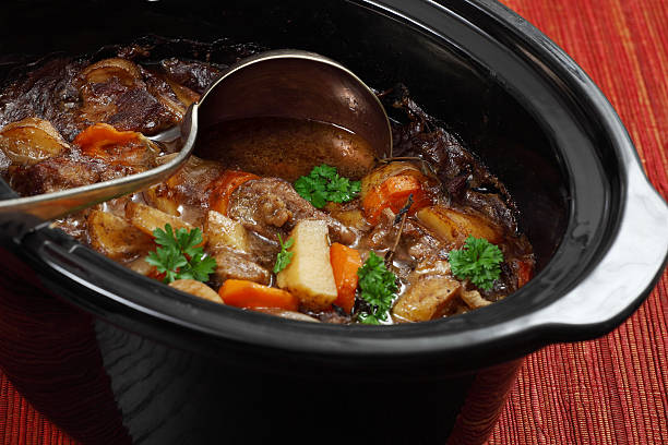 Irish stew in a slow cooker pot Photo of Irish Stew or Guinness Stew made in a crockpot or slow cooker. beef stew stock pictures, royalty-free photos & images