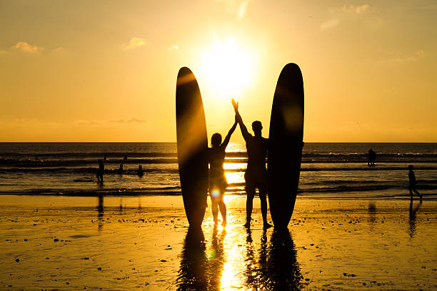 beach surfer silhouette - longboarding surfing bildbanksfoton och bilder