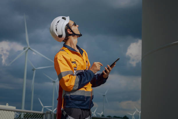 istock Wind Turbine Engineer maintenance using tablets for Inspection and diagnostics at The Wind Turbine Power Station 1787499421
