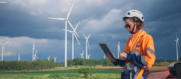 Enhancing Efficiency: Wind Turbine Engineer Uses Tablet for Inspection and Diagnostics During Maintenance