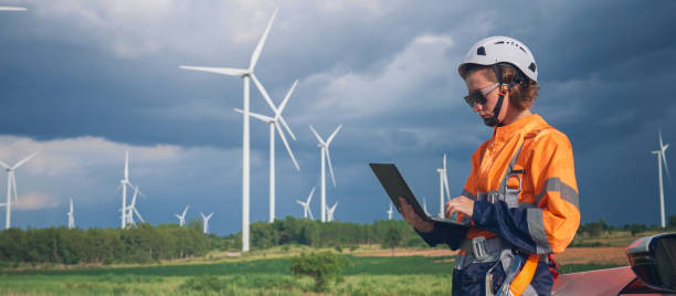 Wind Turbine Engineer woman using tablets for Inspection and diagnostics at The Wind Turbine Power Station stock photo