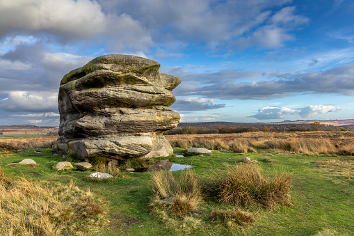 The large boulder known as Eagle Stone on moorland near Baslow Edge in the Peak District National Park, Derbyshire.