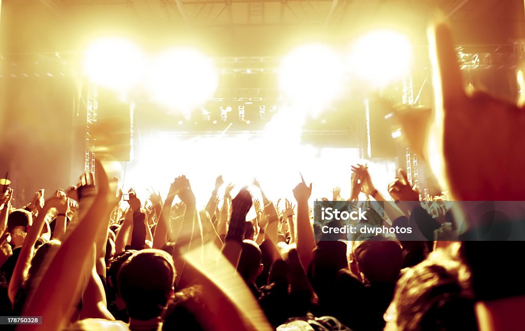 cheering crowd cheering crowd in front of bright stage lights Admiration Stock Photo