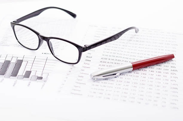 istock Business composition with glasses pen and financial statistics sheets 178750832