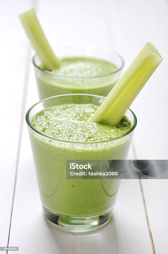 Green vegetable smoothie Green vegetable smoothie with celery and spinach on wooden background Celery Stock Photo