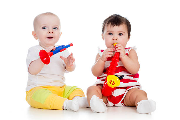 istock Babies girls play musical toy 178752031