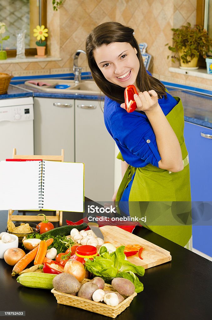 Life in the Kitchen Beautiful smiling woman preparing fresh meal Adult Stock Photo