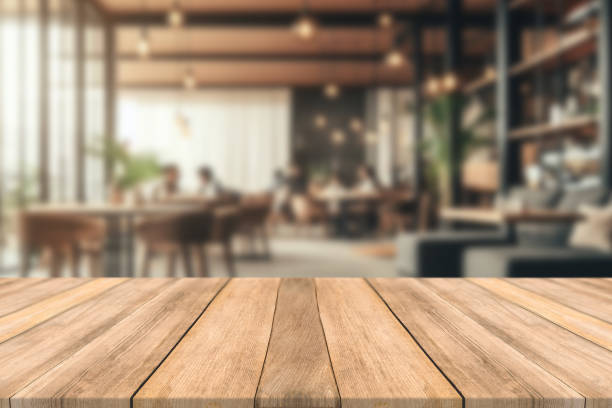 istock Empty wooden table space platform and blurred restaurant or coffee shop background for product display montage 1787525202