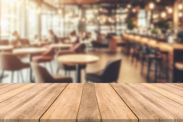 istock Empty wooden table space platform and blurred restaurant or coffee shop background for product display montage 1787525204