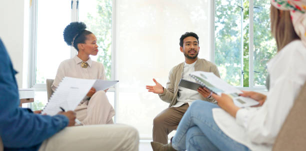 istock Business people in meeting, circle and group at workshop, seminar or training in startup. Team, collaboration or creative designer planning strategy, discussion or brainstorming on tech with document 1787527338