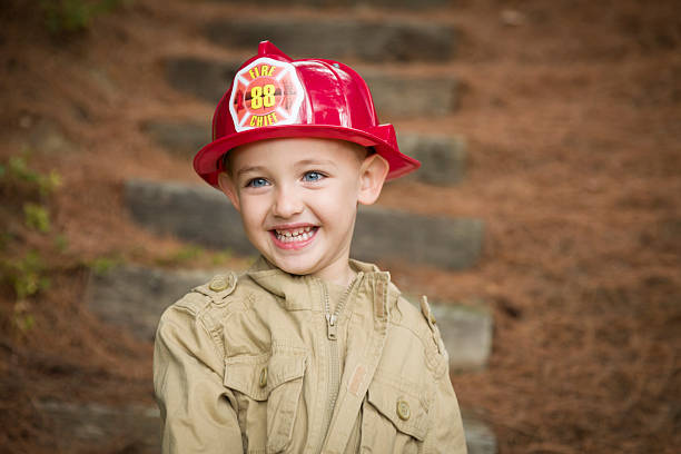 istock Adorable Child Boy with Fireman Hat Playing Outside 178753004