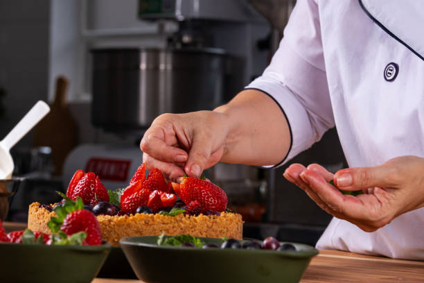 istock female hands decorating a berry pie with fruits 1787532650